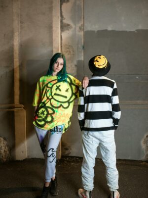 Edgy street fashion featuring vibrant graffiti designs in an urban setting.